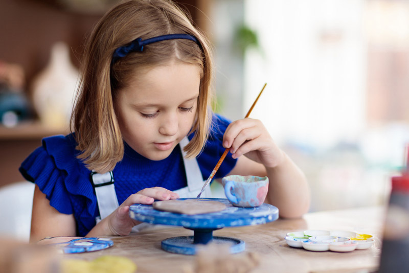 Arts and Crafts for Events Little girl painting ceramics